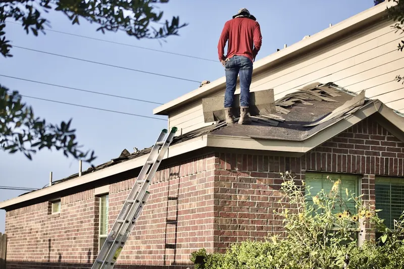 Professional roofer working on a residential roof in Heritage Glen